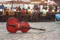 Summer cityscape, street photography, double bass lies on a stone pavement on the Market Square of the Old Town of Lviv