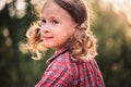 Summer close up outdoor portrait of curly smiling child girl