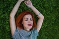 Summer close up portrait of pretty smiling young woman, laying on the grass, enjoy her vacation Royalty Free Stock Photo