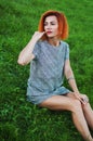 Summer close up portrait of pretty smiling young woman, laying on the grass, enjoy her vacation, natural make up red Royalty Free Stock Photo