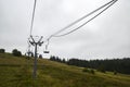 Empty ski lift on the green grassy hill in the Carpathian mountains, Ukraine Royalty Free Stock Photo