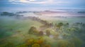 Summer cloudy rainy foggy morning panorama. Rural misty river, fields, meadow, village. Spring overcast moody weather. Blooming Royalty Free Stock Photo