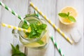 Summer cocktail detox with lemon, ice and mint in mason jar on a white wooden background. Top view. Royalty Free Stock Photo