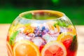 Summer cocktail. Fruit cocktail on green background. Citrus fruits, berries, strawberries, blueberries, mint, ice Royalty Free Stock Photo