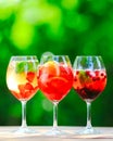 Summer cocktail. Fruit cocktail on green background. Citrus fruits, berries, strawberries, blueberries, mint, ice Royalty Free Stock Photo