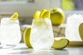 Summer cocktail with green apple and ice on the white table near window in the sunny summertime. Selective focus image with copy Royalty Free Stock Photo