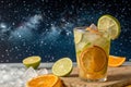 Summer cocktail with lime and oranges under starry sky Royalty Free Stock Photo