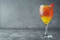Summer cocktail. Orange juice with mint, syrop, fruit slices and cherry with ice. Dark background Royalty Free Stock Photo