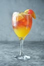 Summer cocktail. Orange juice with mint, syrop, fruit slices and cherry with ice. Dark background Royalty Free Stock Photo