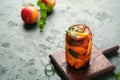 Summer cold drink, iced tea with nectarine or peach, ice and mint in a glass beaker on a green concrete background. Soft drinks, Royalty Free Stock Photo