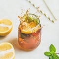 Summer cold Iced tea with lemon and herbs, square crop Royalty Free Stock Photo