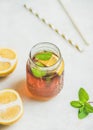 Summer cold Iced tea with lemon slices and fresh herbs Royalty Free Stock Photo