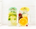 Summer cold infused lemonade with fruits and berries in glass jars Royalty Free Stock Photo