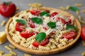 Summer cold pasta salad with fusilli pasta, fresh tomatoes, sun-dried tomatoes, grated Parmesan cheese and fresh green basil Royalty Free Stock Photo