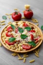 Summer cold pasta salad with fusilli pasta, fresh tomatoes, sun-dried tomatoes, grated Parmesan cheese and fresh green basil Royalty Free Stock Photo