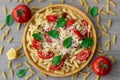 Summer cold pasta salad with fusilli pasta, fresh tomatoes, sun-dried tomatoes, grated Parmesan cheese and fresh green basil Royalty Free Stock Photo