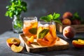 Summer cold peach fizz cocktail or iced tea with mint. Two glasses with peach lemonade on a wooden tray on dark background. Summer Royalty Free Stock Photo