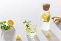 Summer cold refreshing drink. A glass and a bottle of Lemonade with lemon, mint, ice and ginger on white background. Mojito Royalty Free Stock Photo