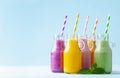 Summer colorful fruit smoothies in jars on blue background. Healthy, detox and diet food concept