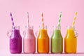 Summer colorful fruit smoothies in jars on pink background. Healthy, detox and diet food concept