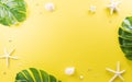 Summer composition concept made from starfish, shell and monstera leaf on yellow background Royalty Free Stock Photo