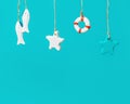 Summer composition with marine items hanging. Sea toys lifeline, seastars and small fish Royalty Free Stock Photo