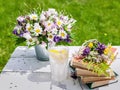 Summer composition. Old books, bouquet of wild flowers, cold lemonade on a rustic background Royalty Free Stock Photo