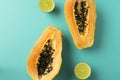 Summer composition. Tropical lime and papaya fruit cut in half lie on a blue background. Summer concept. Flat lay, top Royalty Free Stock Photo