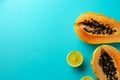 Summer composition. Tropical lime and papaya fruit cut in half lie on a blue background. Summer concept. Flat lay, top Royalty Free Stock Photo