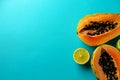 Summer composition. Tropical lime and papaya fruit cut in half lie on a blue background. Summer concept. Flat lay, top Royalty Free Stock Photo