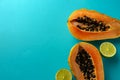 Summer composition. Tropical lime and papaya fruit cut in half lie on a blue background. Summer concept. Flat lay, top Royalty Free Stock Photo