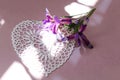 Summer compositions: bouquet of blue irises on a heart-shaped napkin, pastel background, sun rays, space for tex