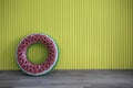 Summer concept.Inflatable watermelon in front of yellow wood wall background on wooden floor. Royalty Free Stock Photo