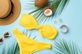 Summer concept. Top view photo of sunhat coconuts gold rings bracelet stylish sunglasses yellow bikini and palm leaves on isolated Royalty Free Stock Photo