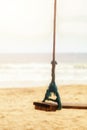 Summer concept. Wood swing hanging from coconut palm tree over beach sea. Asia Thailand. with copy space Royalty Free Stock Photo