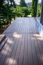 Summer construction, outdoor deck under construction, new manufactured wood planks installed