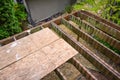 Summer construction, outdoor deck under construction, old support joists with plywood walkway on top