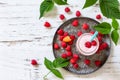 Summer cool milkshake. Raspberry protein shake in glass and fresh raspberry on a wooden table. Top view flat lay background.