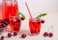 Summer cooling drink with cherries, ice and mint on a white background with copy space Royalty Free Stock Photo