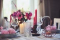 Summer cottage kitchen decorated for festive dinner. Romantic table setting with candles and flowers