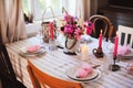 Summer cottage kitchen decorated for festive dinner. Romantic table setting with candles