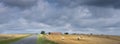 summer countryside landscape with straw bales and barn in french ardennes near charleville