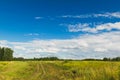 Summer countryside nature landscape. Blue sky white clouds green meadows rural road. Horizontal frame Royalty Free Stock Photo