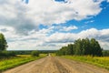 Summer countryside nature landscape. Blue sky white clouds green meadows rural road. Horizontal frame Royalty Free Stock Photo