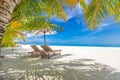 Summer couple destination scenic beach beds chairs umbrella palms. Love romantic travel landscape Royalty Free Stock Photo
