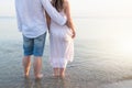 Summer couple embracing at sunset on beach. Romantic young couple enjoying sun, sunshine, romance and love by the sea Royalty Free Stock Photo