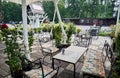 Summer cozy outdoor cafe with flowers and trees around Royalty Free Stock Photo