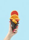 Summer creative concept of fresh citrus ice cream. Healthy party snack made of orange and grapefruit. Pastel blue background Royalty Free Stock Photo