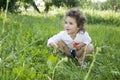 In summer, curly girl standing in the tall grass, and the grass