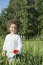 In summer, curly girl standing in the tall grass, and the grass